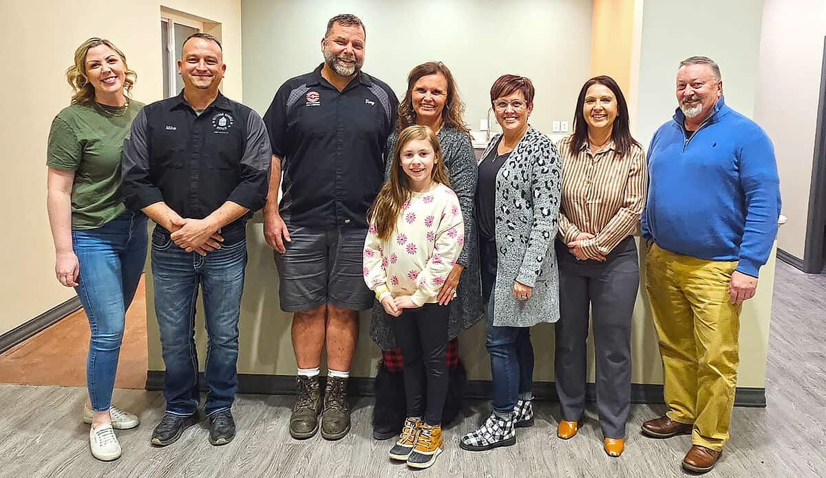 Mike and Jen from Veteran Vehicle Repair standing with Breathe, Inc. and other local supporters.